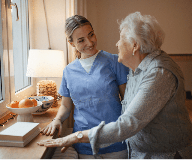 caregiver-and-senior-smile-to-eachother