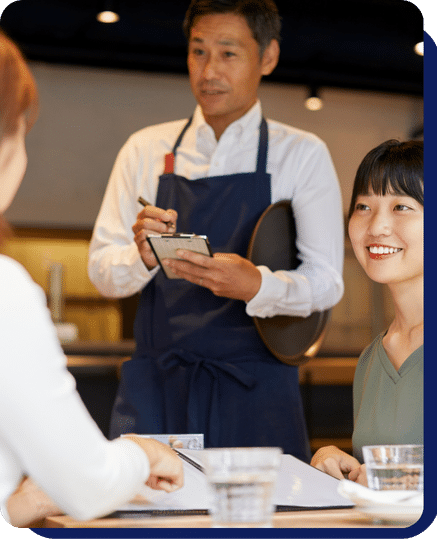 A person standing and asking for order to customer at restaurant