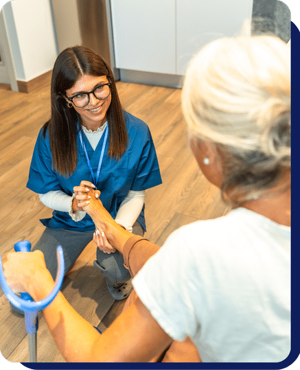 Home caregiver smiling with an older woman